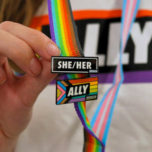 Load image into Gallery viewer, black enamel pronoun pin she / her on rainbow lanyard