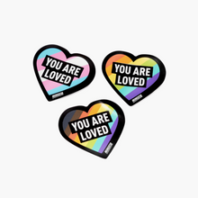 Load image into Gallery viewer, "You Are Loved" LGBTQIA+ stickers, heart shaped. Rainbow, trans flag, and POC rainbow
